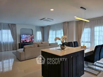 Spacious modern living room with elegant dining area and natural light.