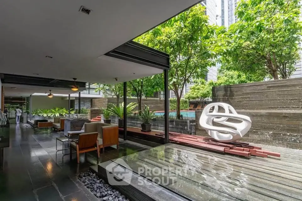 Luxurious modern outdoor area with pool and stylish seating in a high-end residential complex.