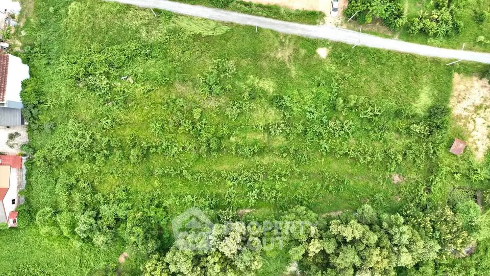 Expansive aerial view of lush green land ideal for development opportunities.