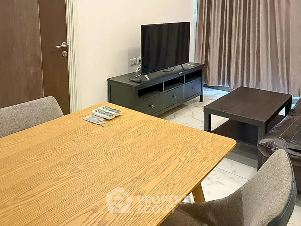 Modern living room with sleek furniture and TV, perfect for relaxation and entertainment.