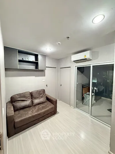 Modern living room with sleek design and air conditioning in a cozy apartment.