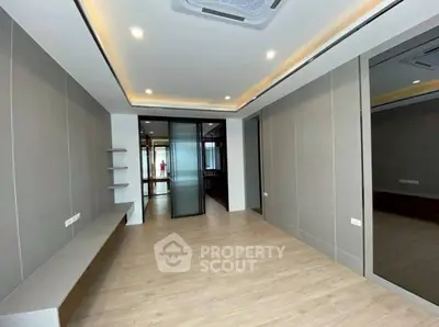 Modern minimalist interior with sleek design and wooden flooring, ideal for versatile living spaces.