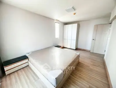 Spacious bedroom with modern minimalist design and ample natural light
