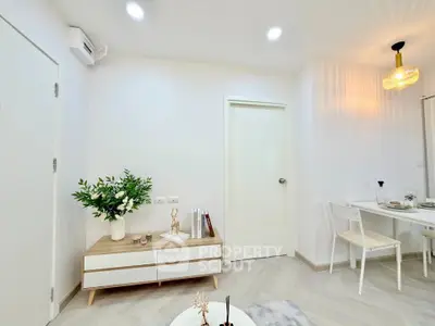 Modern living room with elegant decor and dining area, featuring minimalist furniture and bright lighting.