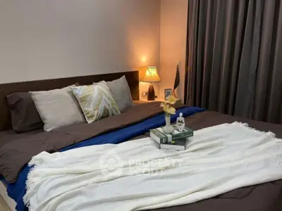 Cozy bedroom with elegant decor and soft lighting, perfect for relaxation and comfort.