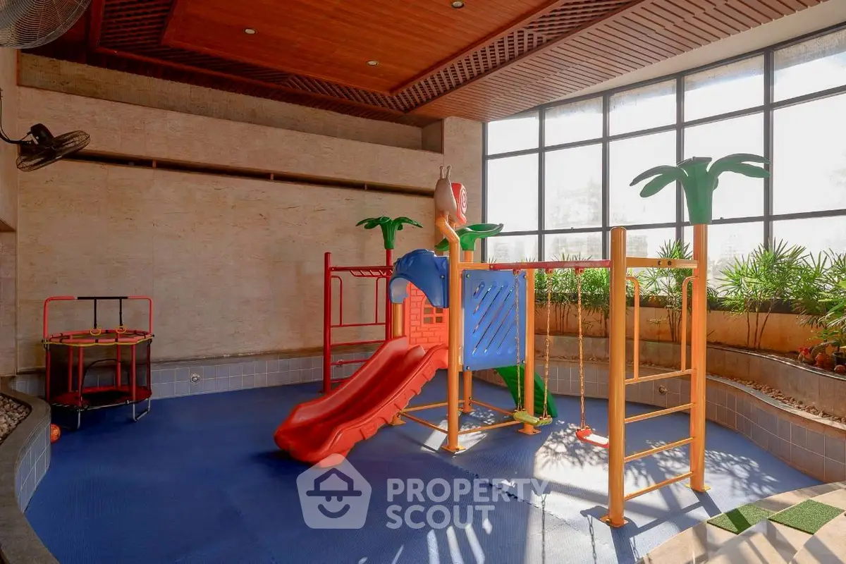 Spacious indoor play area with colorful slide and natural light, perfect for family-friendly living.
