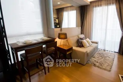 Modern living room with cozy sofa and dining area in open layout apartment.