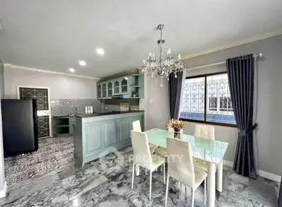Elegant kitchen and dining area with chandelier and modern decor