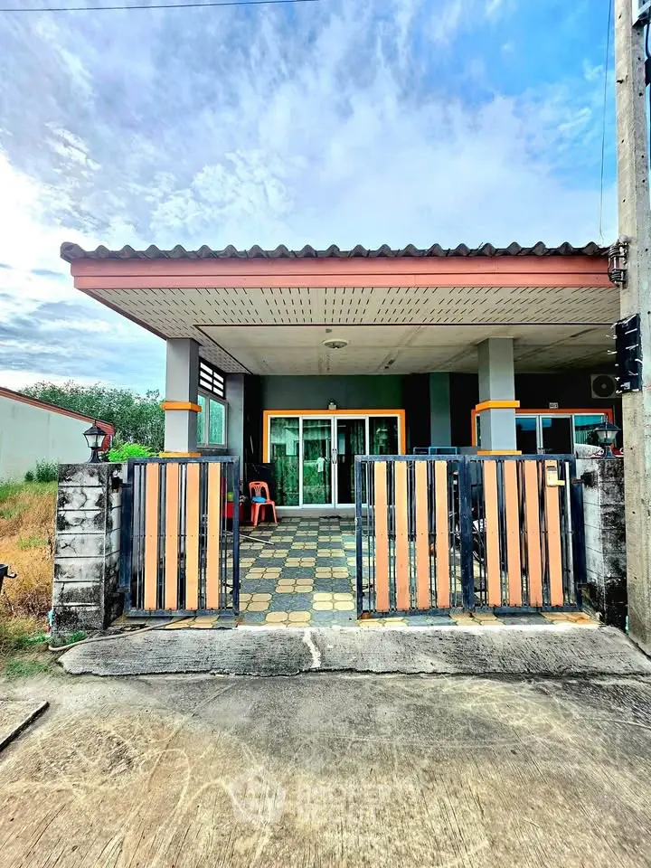 Charming single-story home with gated entrance and spacious front patio, perfect for outdoor relaxation.