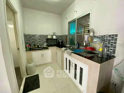 Charming kitchen with modern backsplash and ample storage space