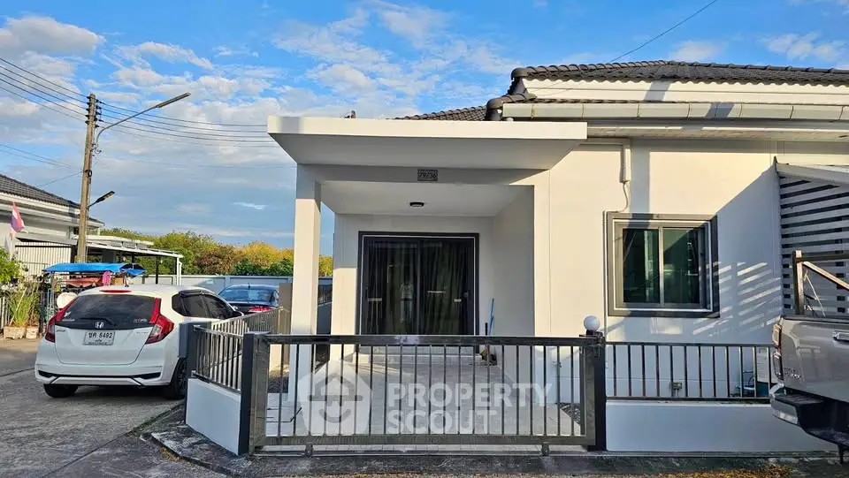 Charming single-story home with modern facade and spacious driveway in a serene neighborhood.