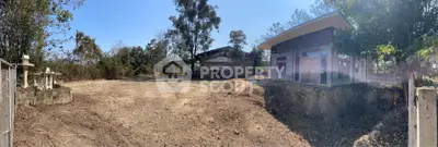 Expansive rural property with modern building and open land, ideal for development or agriculture.