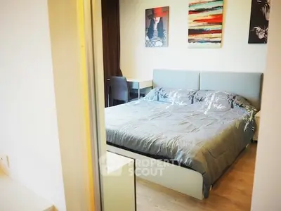 Modern bedroom with stylish decor and cozy ambiance, featuring a comfortable bed and artistic wall art.