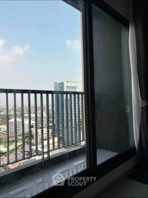 Stunning city view from high-rise apartment balcony with modern railing.