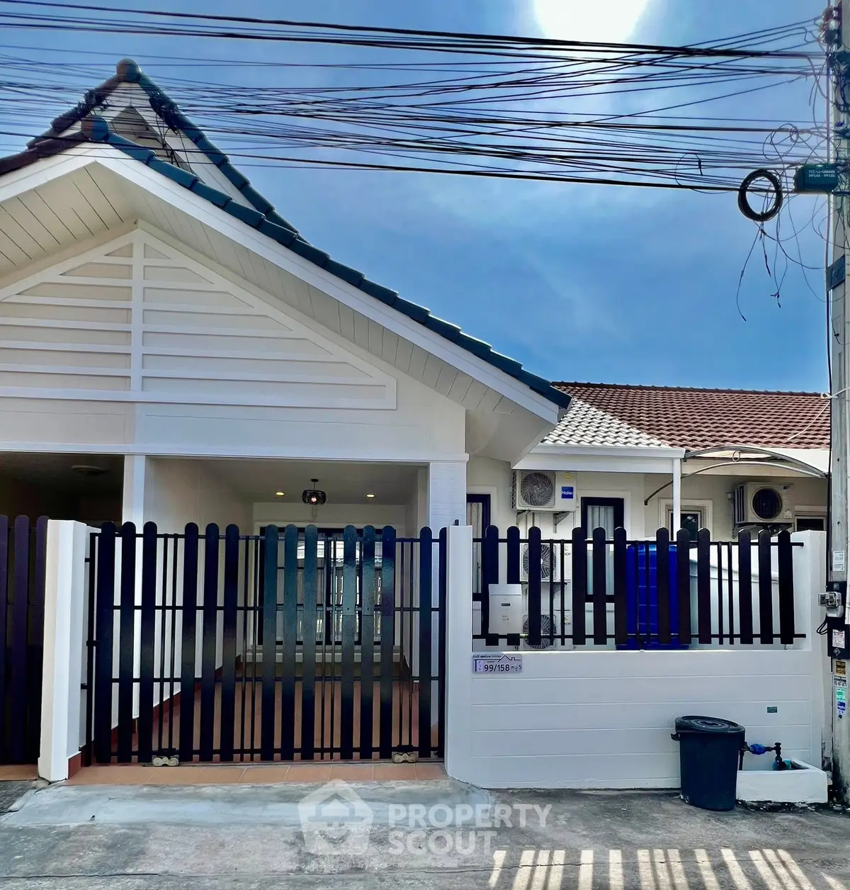 Charming single-story home with gated entrance and modern exterior design.