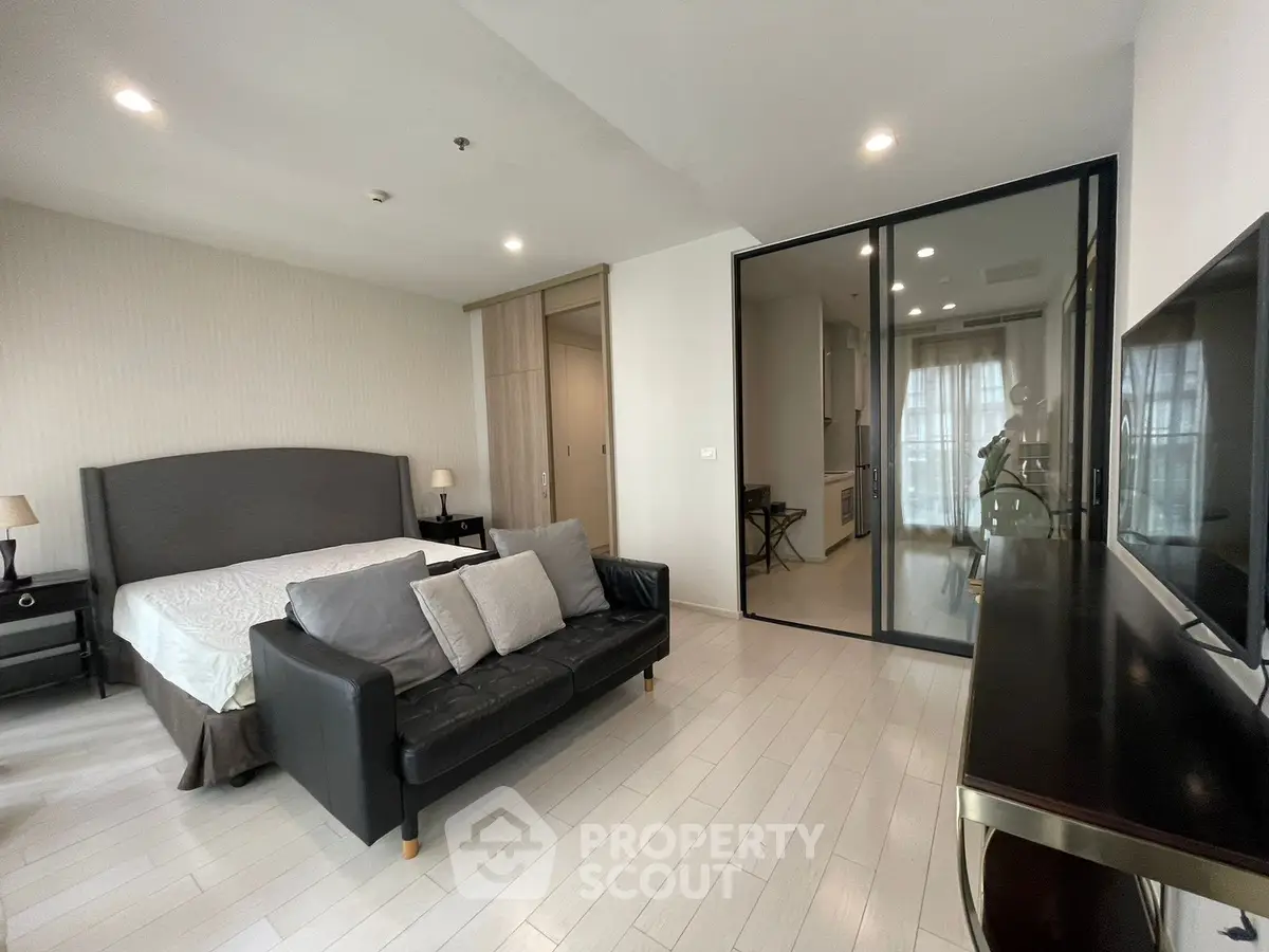 Spacious modern bedroom with elegant decor and natural light
