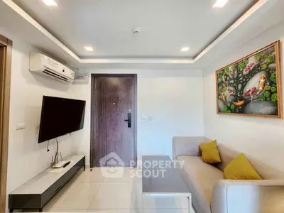 Modern living room with sleek design, featuring a wall-mounted TV, air conditioning, and stylish decor.