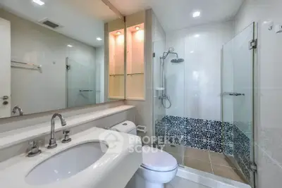 Modern bathroom with glass shower and stylish tile design