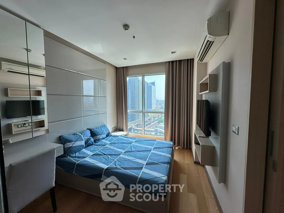 Modern bedroom with city view, featuring stylish decor and natural light.