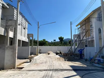 Newly constructed residential area with modern buildings and clear blue sky.