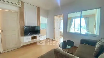 Modern living room with city view, featuring sleek furniture and natural light.