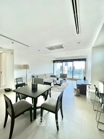 Spacious modern living room with city view and elegant dining area