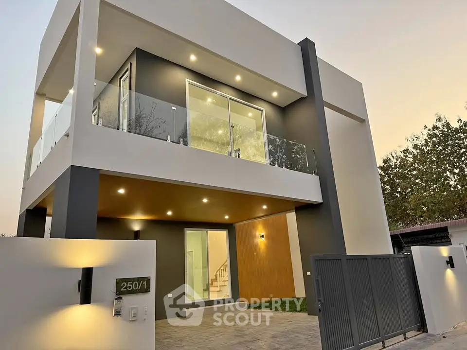 Modern two-story house with sleek design and glass balcony, perfect for contemporary living.