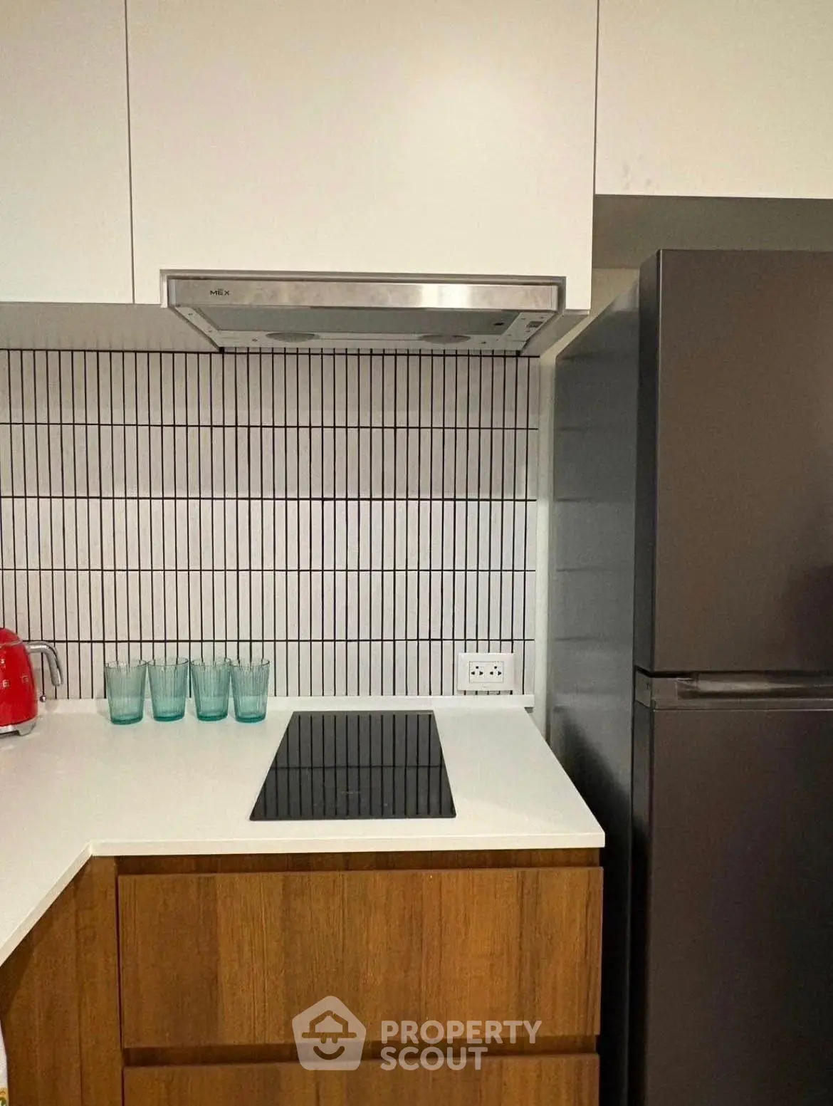 Modern kitchen with sleek appliances and stylish backsplash
