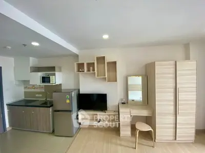 Modern studio apartment with compact kitchen and stylish furniture
