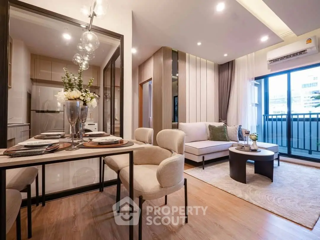 Modern living room with elegant dining area and balcony access, featuring stylish decor and ample natural light.