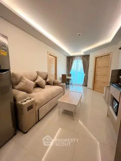 Modern living room with cozy beige sofa, sleek furniture, and ambient lighting in a stylish apartment.