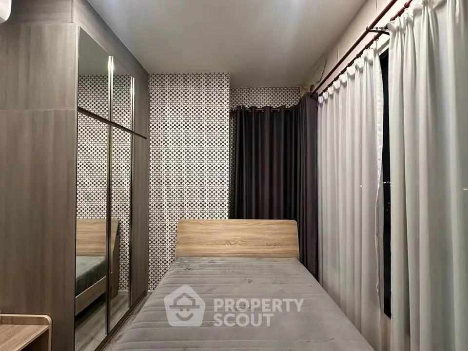 Cozy bedroom with modern decor and large mirrored wardrobe