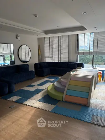 Spacious living room with modern furniture and play area for children