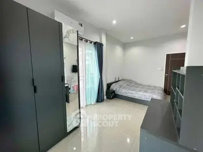 Modern bedroom with sleek wardrobe and large window for natural light