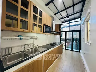 Modern kitchen with sleek cabinetry and gas stove in a bright, airy space.