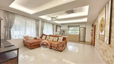 Spacious living room with modern kitchen, cozy sectional sofa, and elegant ceiling design.