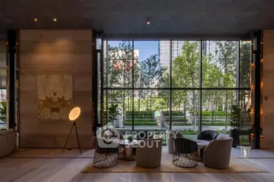 Luxurious modern living room with floor-to-ceiling windows and stunning garden view.