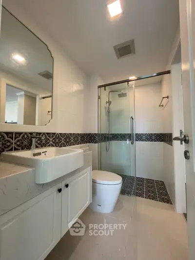 Modern bathroom with glass shower and stylish tile accents