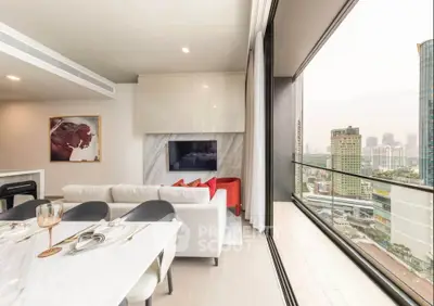 Luxurious modern living room with stunning city view from high-rise balcony, elegant decor and open layout.