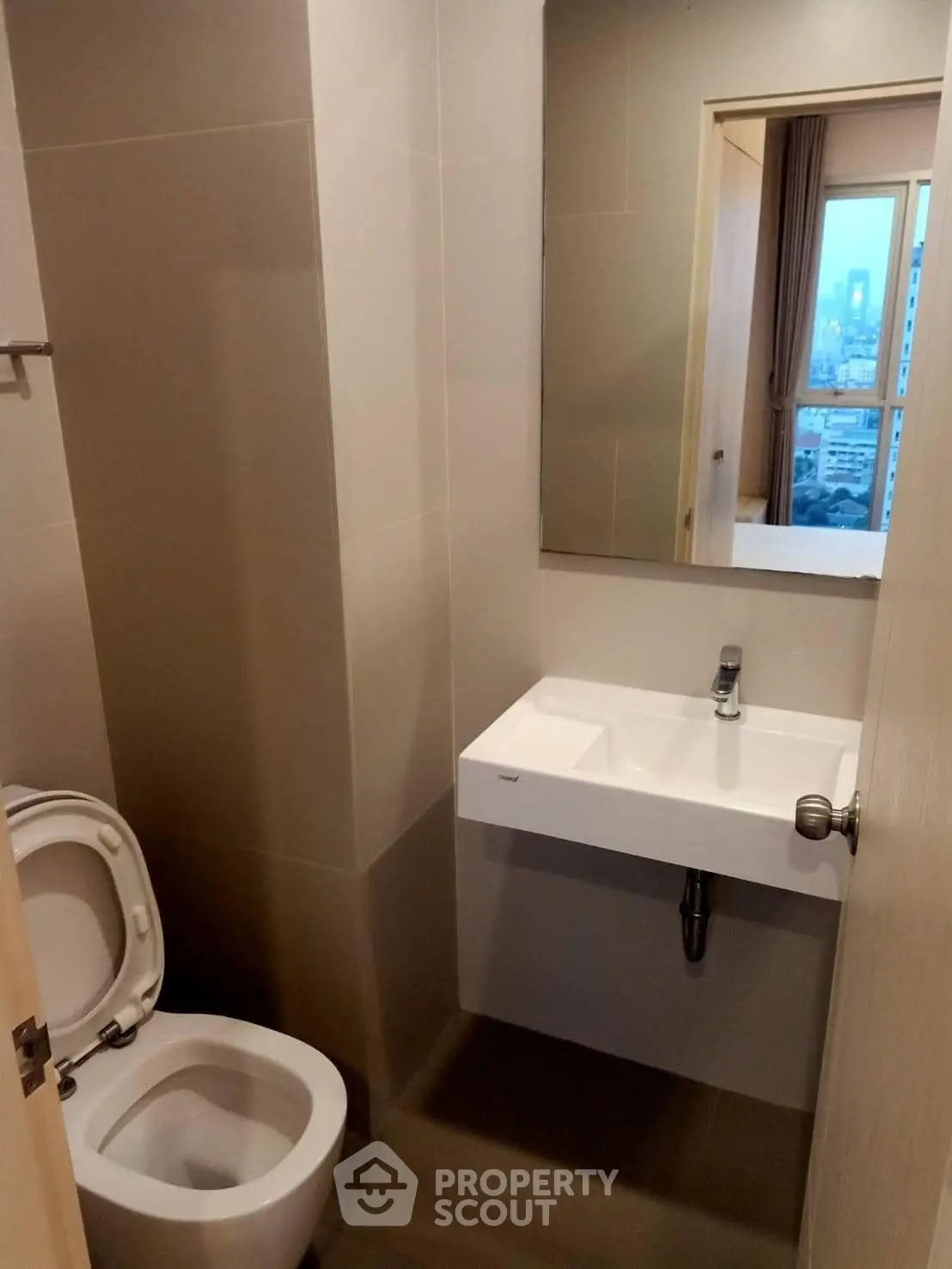 Modern bathroom with sleek sink and city view from window
