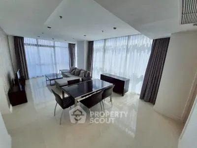 Spacious modern living room with large windows and elegant furnishings