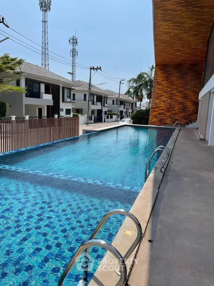 Luxurious outdoor swimming pool with modern design in a residential complex, perfect for relaxation and leisure.