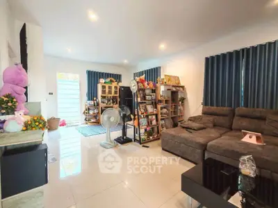 Spacious living room with modern decor and cozy seating area, perfect for relaxation and entertainment.