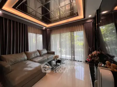Luxurious living room with modern decor, large windows, and elegant lighting.