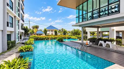 Luxurious residential complex with stunning outdoor pool and modern architecture.
