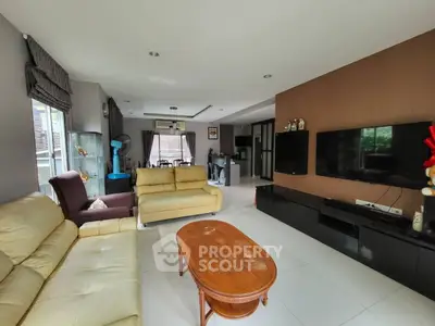 Spacious living room with modern decor and large TV setup