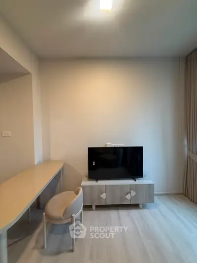 Modern living room with sleek TV stand and stylish furniture, perfect for contemporary living.