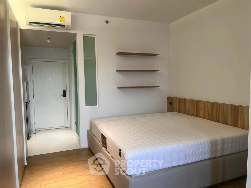 Modern bedroom with minimalist design and wooden flooring
