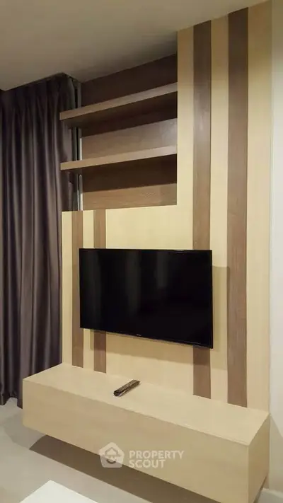 Modern living room with stylish TV wall unit and elegant curtains