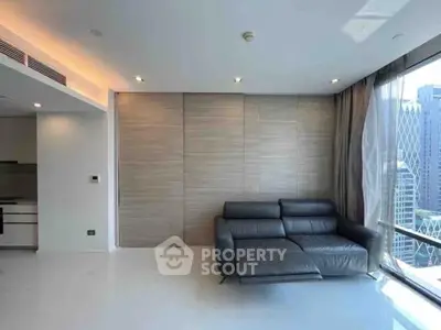 Modern living room with sleek black sofa and panoramic city view, perfect for urban living.